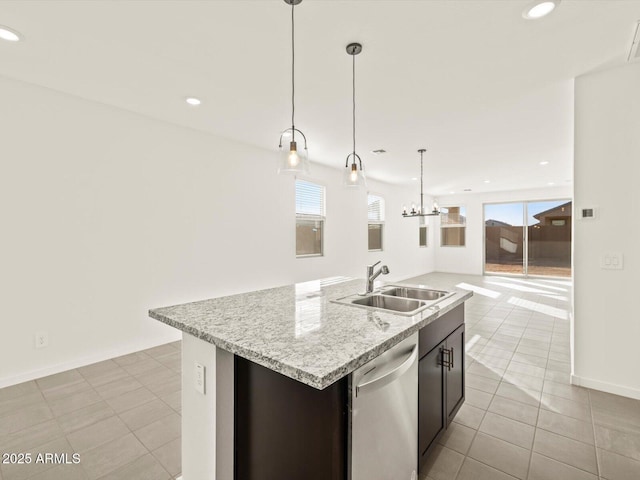 kitchen featuring sink, an island with sink, light tile patterned flooring, decorative light fixtures, and stainless steel dishwasher