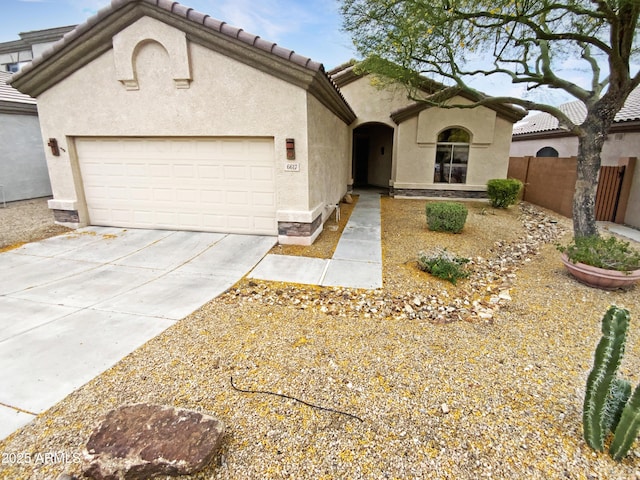 mediterranean / spanish-style house featuring concrete driveway, stucco siding, an attached garage, fence, and a tile roof