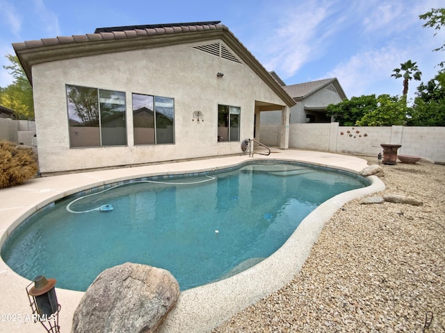 view of swimming pool with fence and a patio area