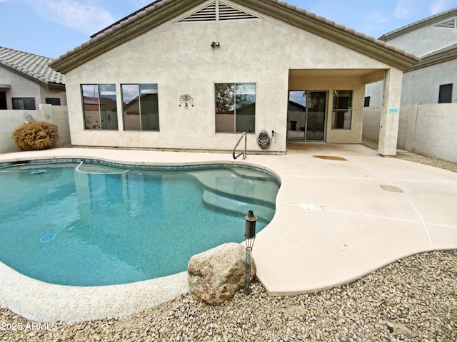 view of swimming pool with fence and a patio