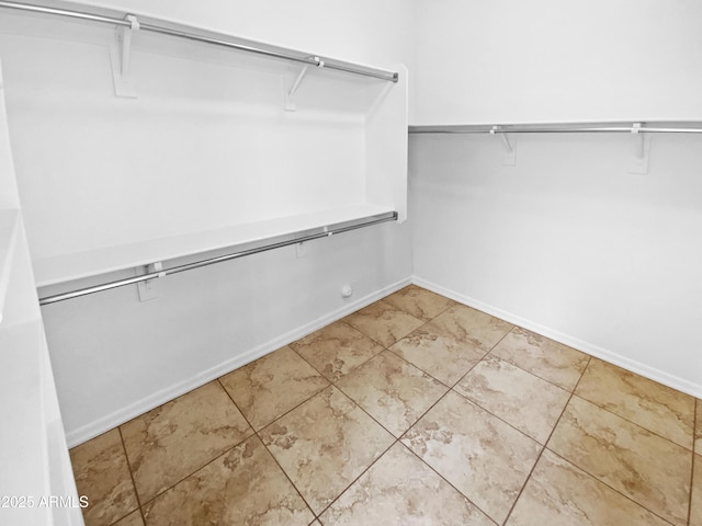 spacious closet with tile patterned floors