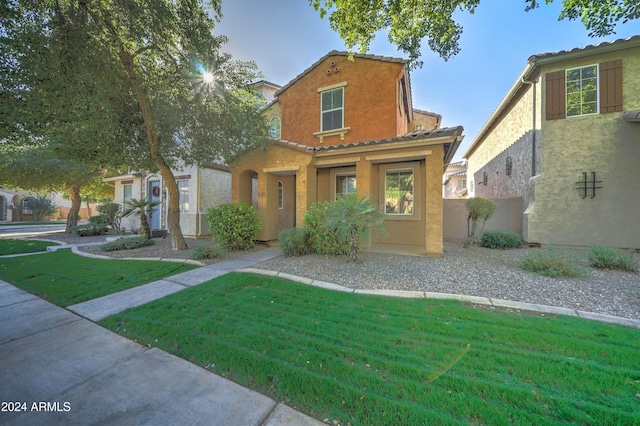 mediterranean / spanish house featuring a front yard