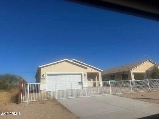 single story home featuring a garage, driveway, and fence