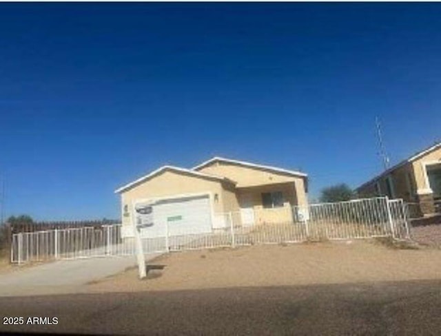 view of front of home with a fenced front yard and concrete driveway