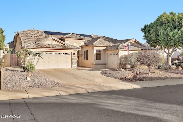 view of front of home with a garage and solar panels