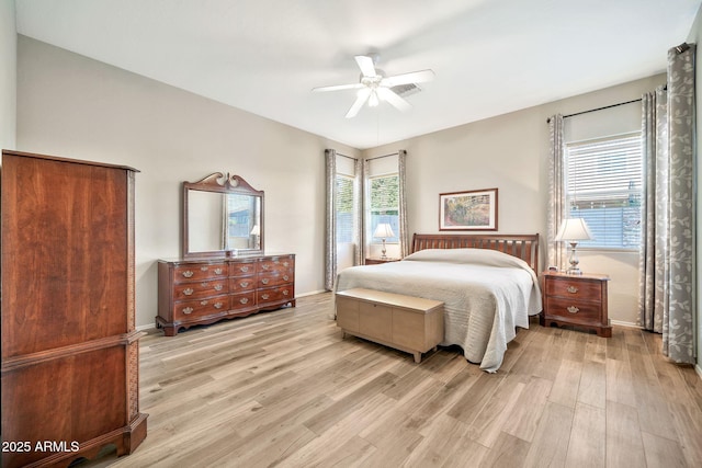 bedroom with ceiling fan and light hardwood / wood-style flooring