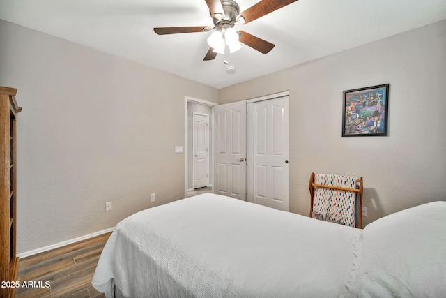 bedroom featuring a closet, dark hardwood / wood-style floors, and ceiling fan