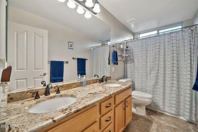 bathroom with vanity, curtained shower, tile patterned floors, and toilet