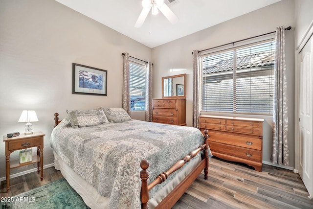 bedroom with hardwood / wood-style flooring, ceiling fan, and a closet