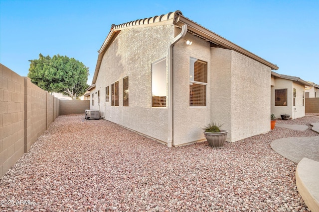 view of home's exterior featuring central AC unit and a patio