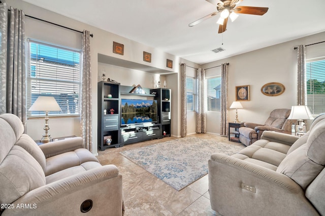 tiled living room featuring ceiling fan