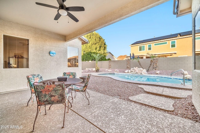 view of patio with ceiling fan and a fenced in pool