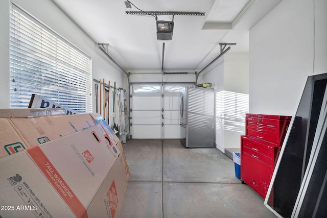 garage featuring a garage door opener and stainless steel fridge