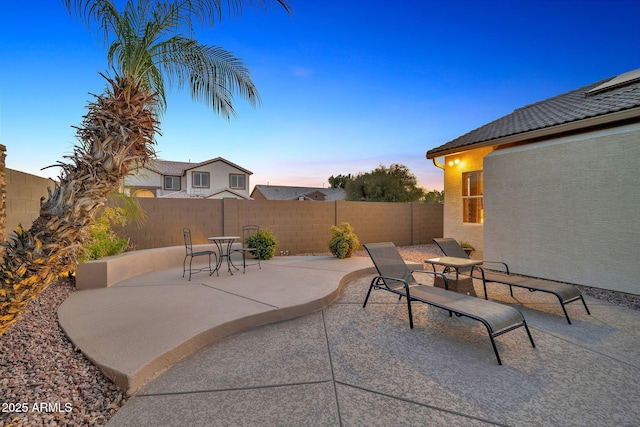 view of patio terrace at dusk