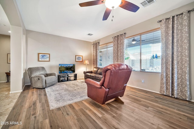 living room with ceiling fan and hardwood / wood-style floors