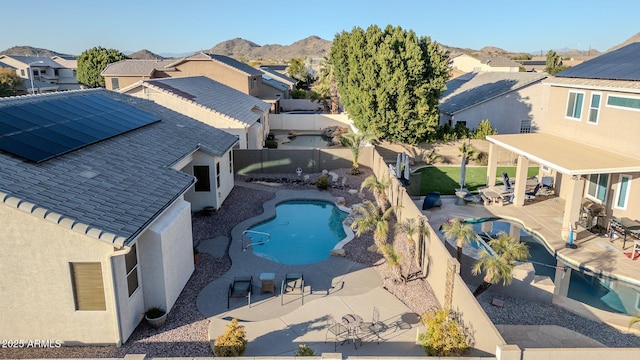 view of pool with a mountain view and a patio area