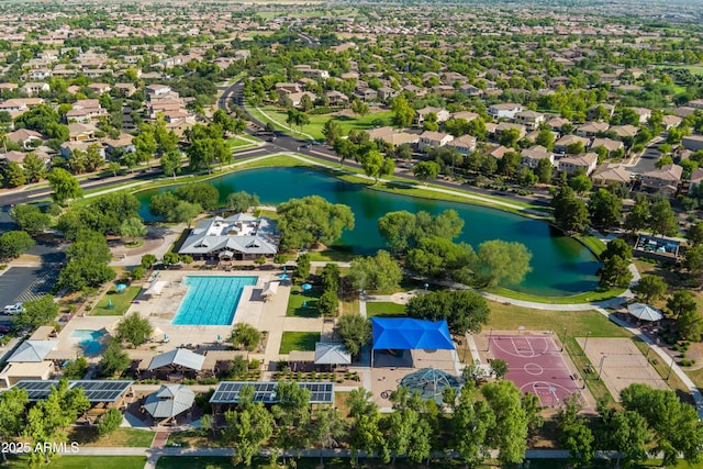 drone / aerial view featuring a water view and a residential view