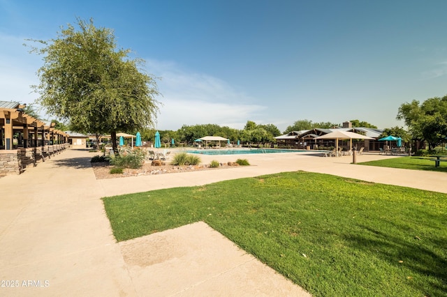 view of home's community with a pool, a lawn, and a gazebo