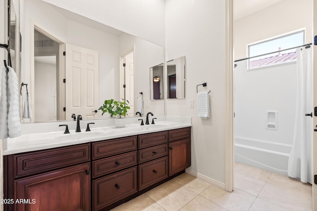 full bathroom featuring double vanity, tile patterned flooring, a sink, and shower / bath combo