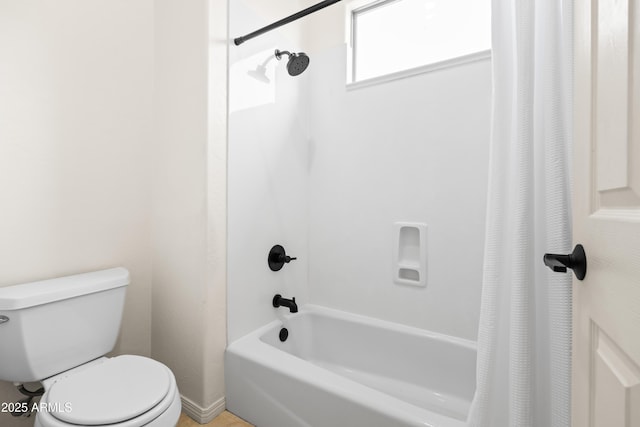 full bathroom featuring shower / bath combo and toilet