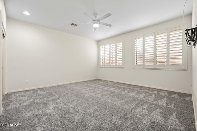 unfurnished room featuring baseboards, visible vents, ceiling fan, and carpet flooring