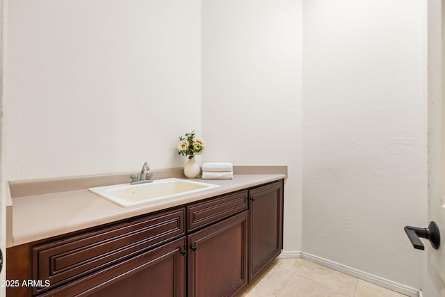 bathroom with tile patterned floors, baseboards, and vanity