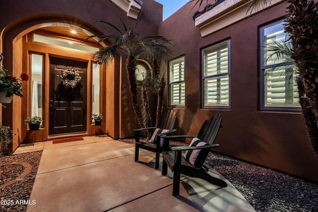 doorway to property with stucco siding