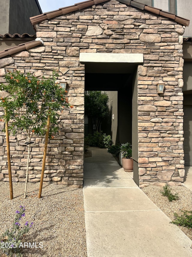 property entrance with stone siding
