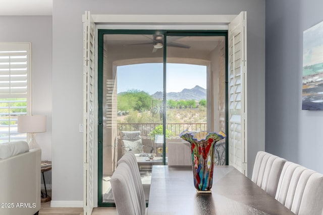 19550 N Grayhawk Dr Unit 2023, Scottsdale, AZ 85255 - dining space with a mountain view, ceiling fan, and wood finished floors
