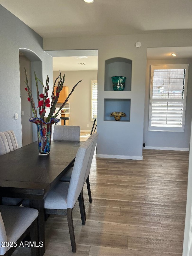 dining room with baseboards and wood finished floors
