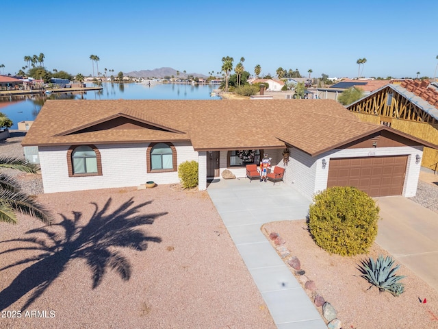 view of front of property featuring a water view and a garage