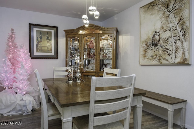 dining space with dark wood-type flooring