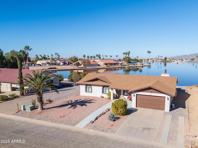 view of front of home featuring a water view and a garage