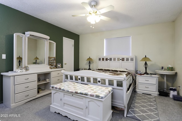 carpeted bedroom featuring a textured ceiling and ceiling fan