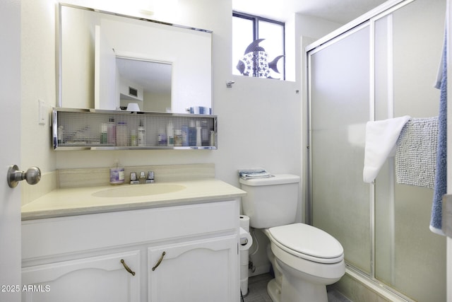 bathroom with vanity, toilet, and walk in shower