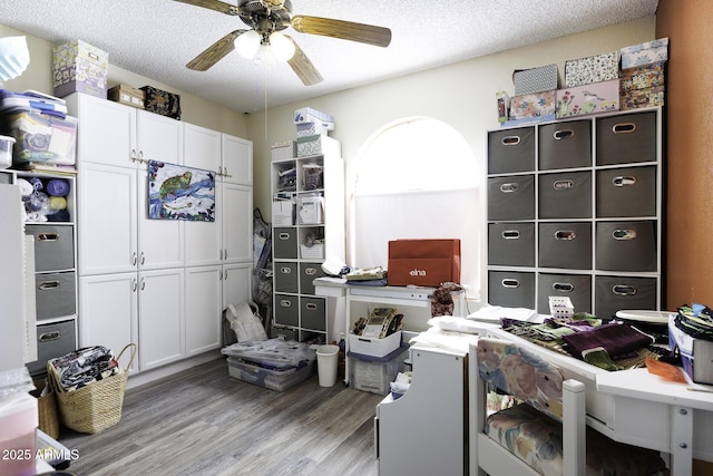 interior space with a textured ceiling, light hardwood / wood-style flooring, and ceiling fan