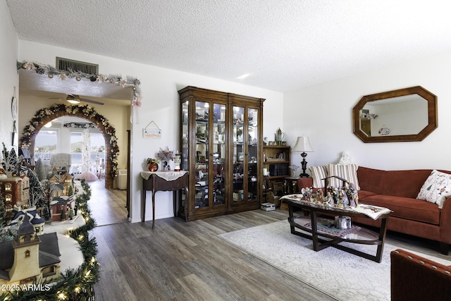 living room featuring hardwood / wood-style flooring and a textured ceiling