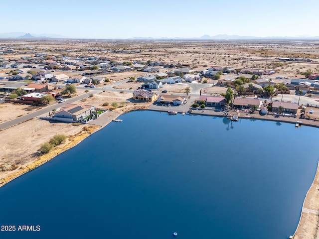 birds eye view of property with a water and mountain view