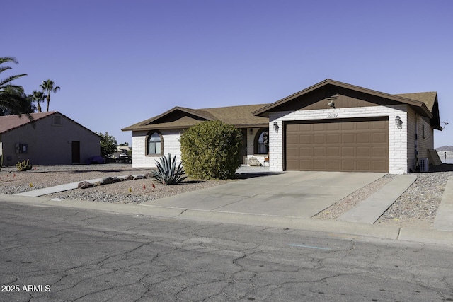 view of front of home featuring a garage and central air condition unit