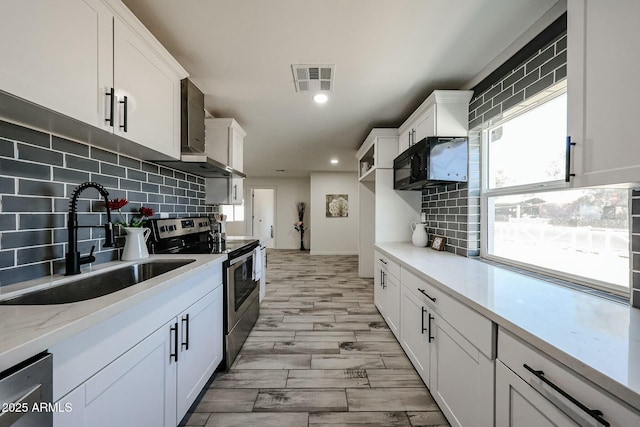 kitchen featuring sink, plenty of natural light, white cabinets, and appliances with stainless steel finishes