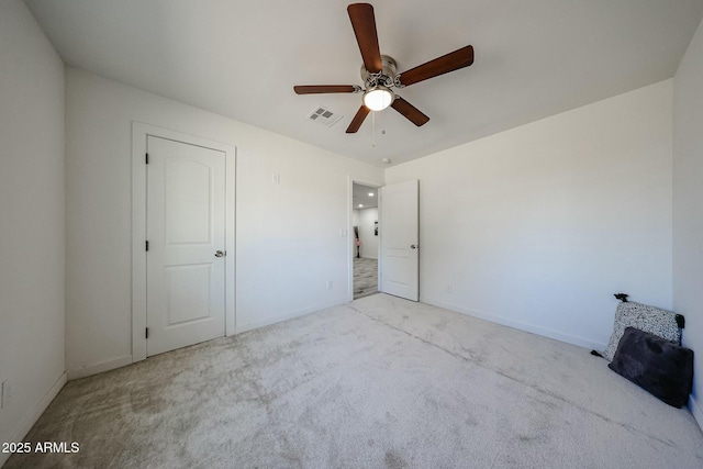 unfurnished bedroom featuring light colored carpet and ceiling fan