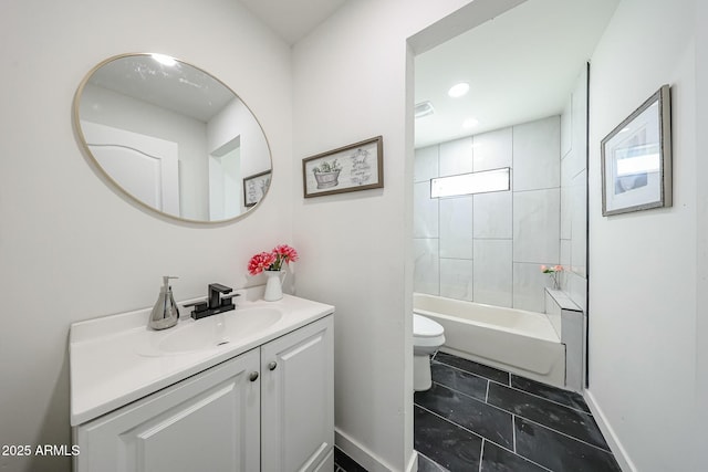 full bathroom featuring tiled shower / bath combo, vanity, and toilet