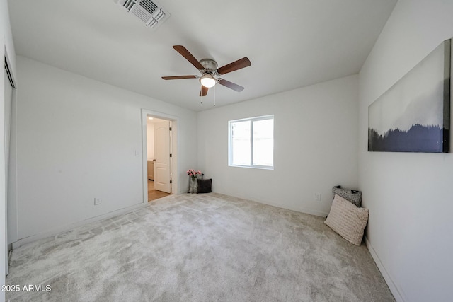 unfurnished bedroom featuring light carpet and ceiling fan