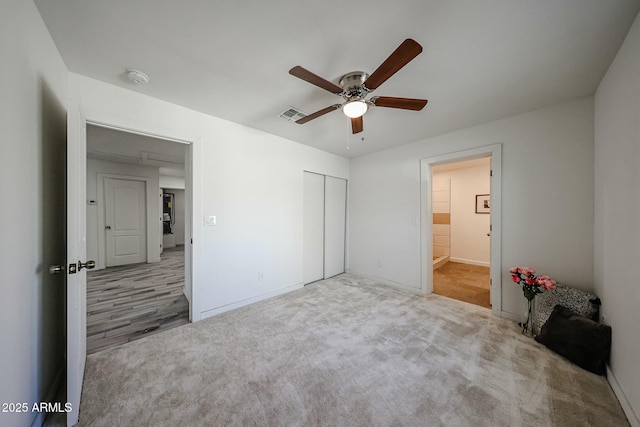 unfurnished bedroom featuring a closet, ceiling fan, and carpet