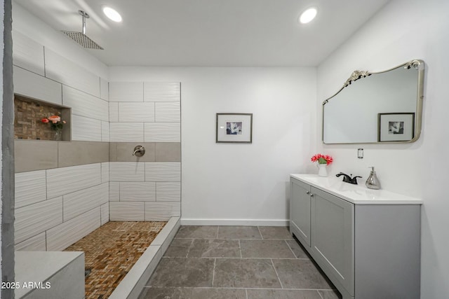 bathroom with vanity and tiled shower