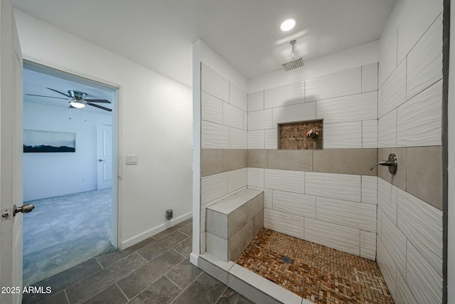 bathroom featuring a tile shower and ceiling fan