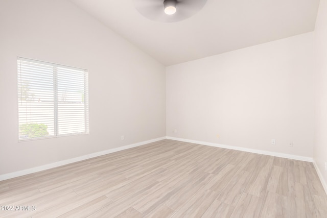 empty room featuring ceiling fan, light hardwood / wood-style floors, and high vaulted ceiling