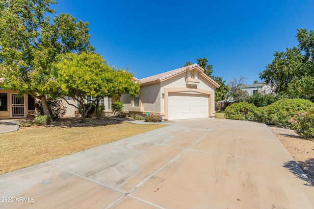 view of front of property with a front yard and a garage