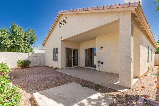 back of property featuring a patio