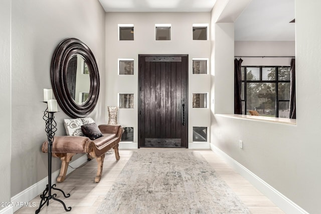 entrance foyer featuring wood finished floors and baseboards